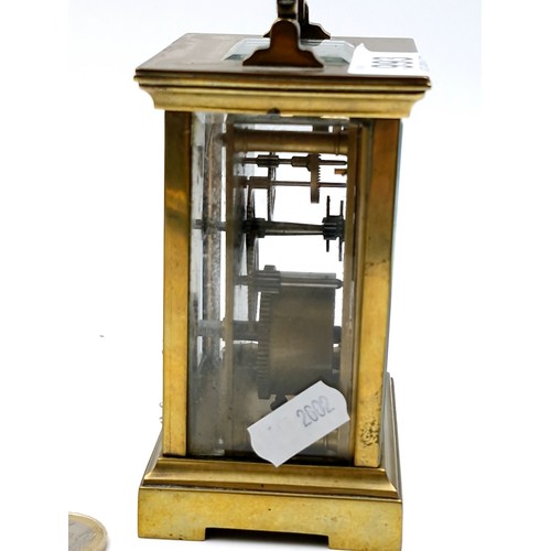 993 - A good antique brass French mechanical carriage clock with glass sides and top.