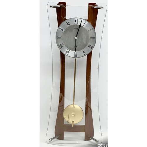 1123 - Wall clock featuring a wooden frame with curved glass design, central metal clock face, and Roman nu... 