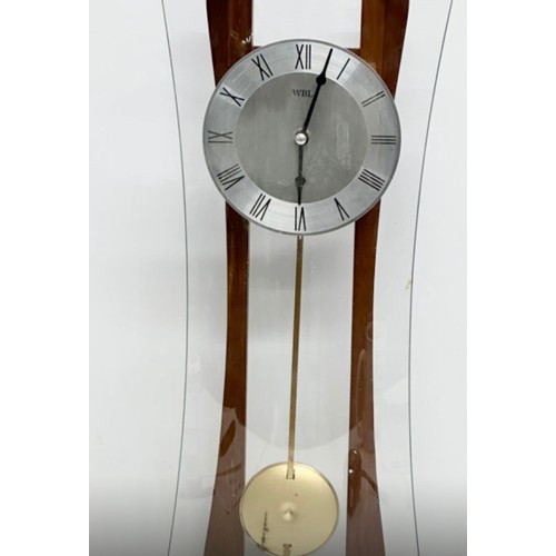 1123 - Wall clock featuring a wooden frame with curved glass design, central metal clock face, and Roman nu... 