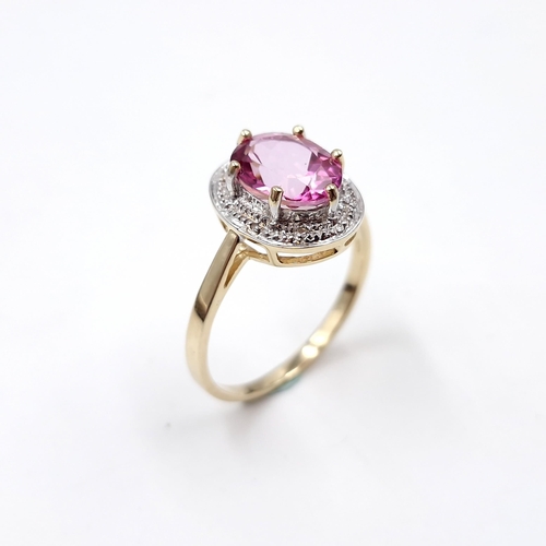 1 - Star Lot : A beautiful nine carat gold large pink spinal gemstone ring set with diamond surround. Si... 