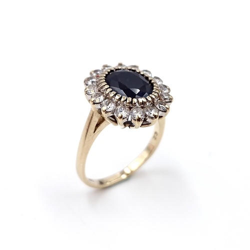 10 - Star lot : A stunning nine carat gold sapphire stone ring set with cubic zirconia surround. Ring siz... 