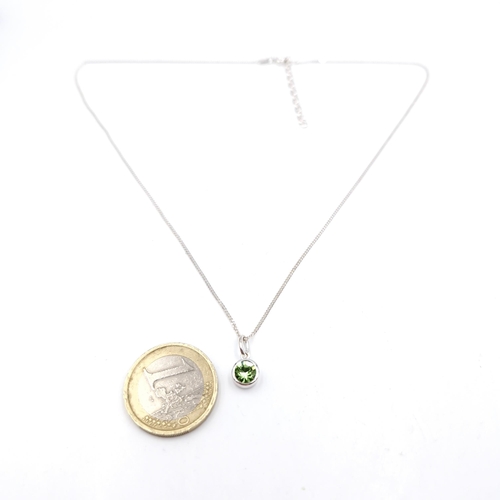 22 - A sterling silver pendant chain. Pendant set with peridot stone. Length of chain - 44 cms. Weight - ... 