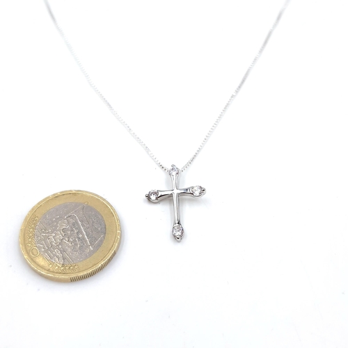 25 - A sterling silver pendant cross with gem set detailing and silver chain. Length - 42 cms. Weight - 2... 