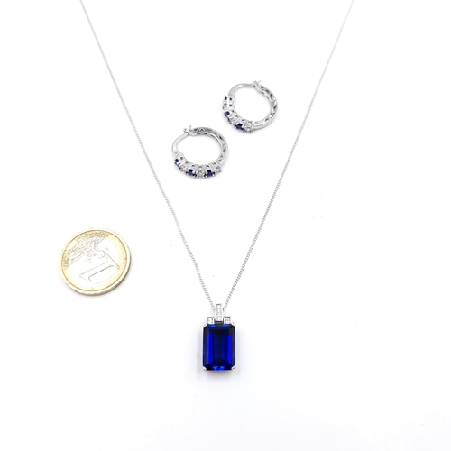 29 - A matching set consisting of a blue stone pendant Silver with gem set accents and chain. Length - 44... 