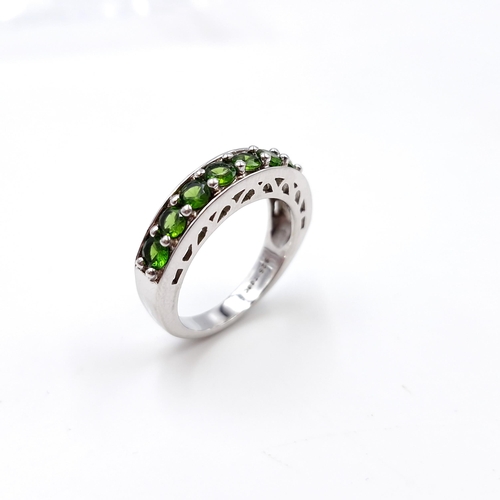 31 - A pretty green gemstone half eternity ring set in sterling silver. Ring size - M 1/2. Weight - 4.5 g... 