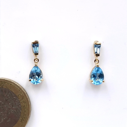 4 - Star lot : A lovely pair of nine carat gold stud earrings set with blue topaz gemstones. weight - 1.... 