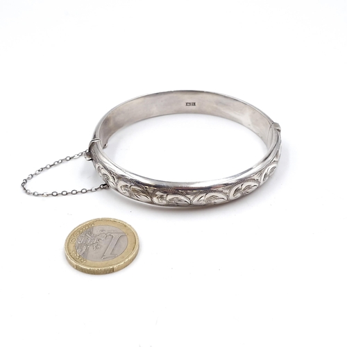 406 - A vintage  sterling silver bracelet with foliette detailing hallmarked Birmingham with safety chain.... 