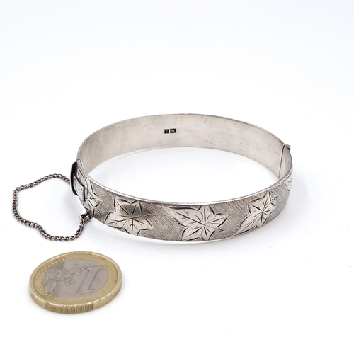 410 - A vintage hallmarked silver Birmingham floral designed bracelet with safety chain. Weight - 38.6 gra... 