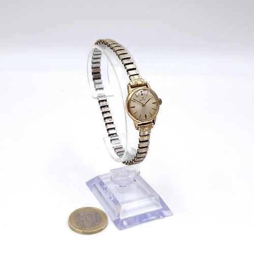 413 - Star Lot : A vintage Omega ladies wristwatch with gold toned case set with patterned hands and exten... 