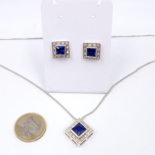 417 - A matching set of jewellery consisting of a blue stone pendant necklace. Length - 40 cms. Together w... 