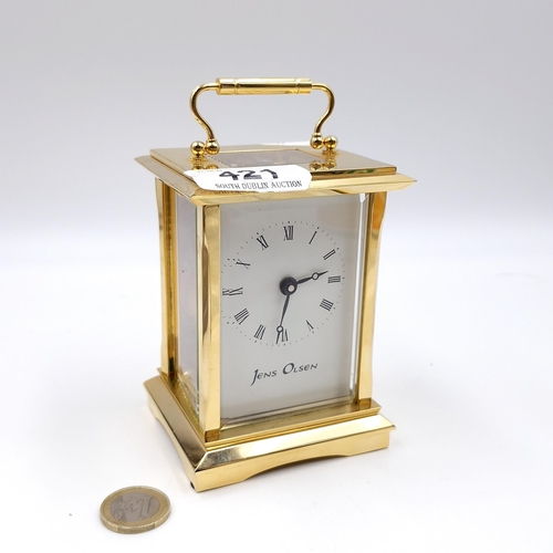 421 - A lovely example of a brass carriage clock by Jens Olsen with inspection aperture set with white ena... 