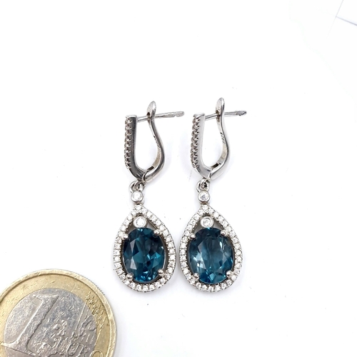 428 - A pair of blue topaz & gemstone pendant earrings marked 925 suitable for pierced ears. Drop - 4 cms.... 