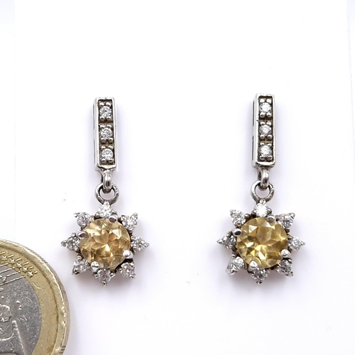 429 - A pair of sterling silver citrine and gem set stud earrings. Weight - 3.9 grams. Boxed.