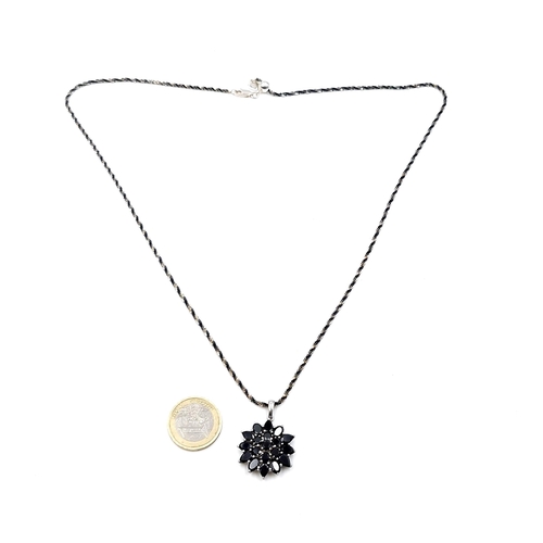 430 - A sterling silver onyx star burst pendant with a good bright cut sterling silver chain with heart cl... 