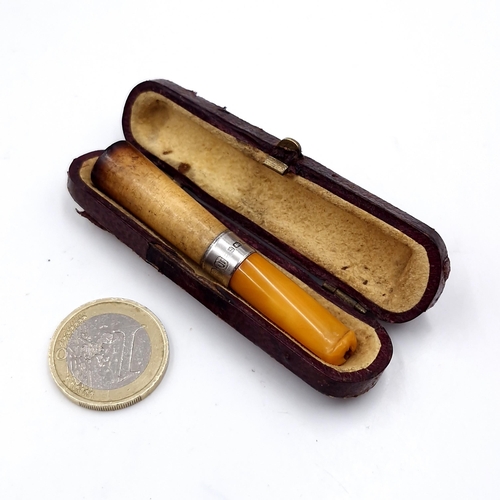 455 - A nice example of an amber cigarette holder with sterling silver collar hallmarked Birmingham. Conta... 