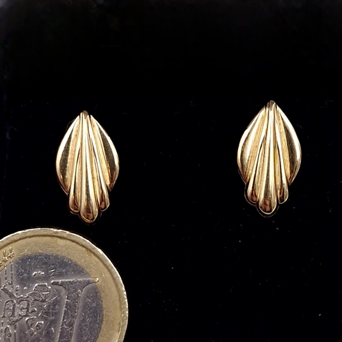 457 - A pair of nine carat gold shell designed stud earrings. - marks to backs. Total weight - 0.55 grams.... 