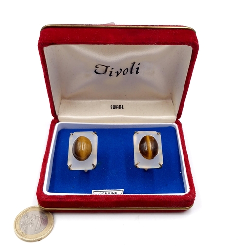 464 - A nice example of a pair of genuine Tiger's eye cuff links by Tivoli. Contained in original presenta... 