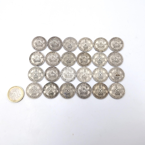 467 - A collection of 24 UK silver shilling coins dated 1940 - 1946. Total weight - 135.93 grams.