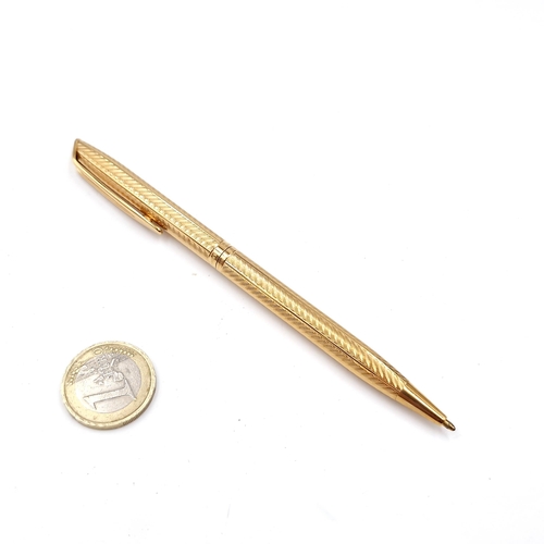 47 - A gold toned ballpoint pen set with machine cut detailing by Waterman's made in France.