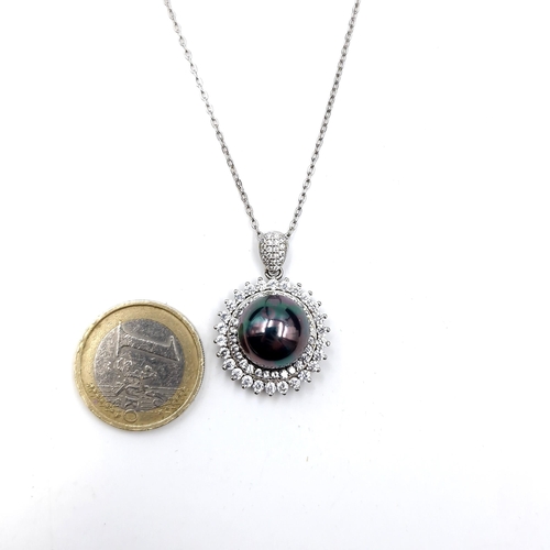 480 - A mystic topaz pearl pendant with cubic zirconia surround and silver chain. Length - 44 cms. Weight ... 