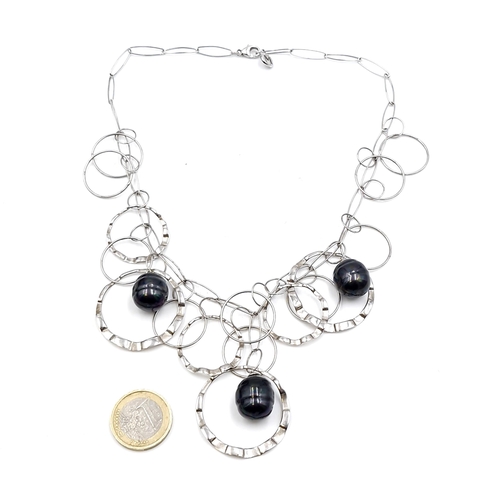 482 - A handmade sterling silver mounted collarette set with peacock pearl coloured accents. Length - 38 c... 