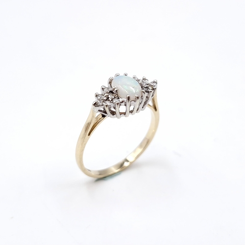 5 - Star lot : A lovely example of a nine carat gold opal gemstone set ring with diamond shoulders. Size... 