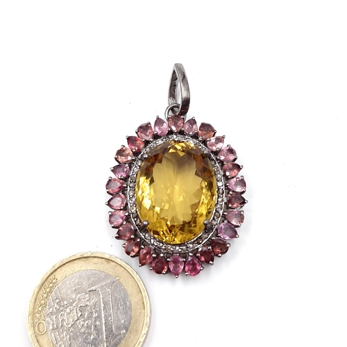 56 - Star Lot : A nice quality citrine stone pendant set with pink tourmaline & diamond surround. Diamond... 