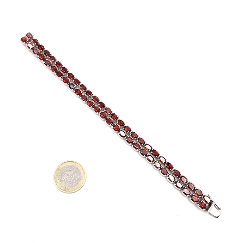 57 - Star Lot : A very pretty double row garnet gemstone silver bracelet set with double clasp. Weight - ... 