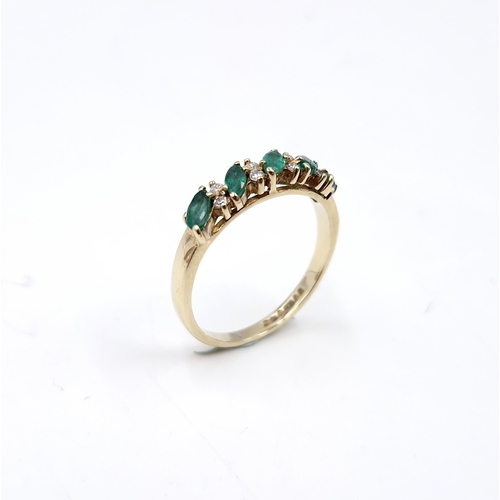 6 - Star lot : A five stone emerald ring set with diamonds. Ring size - M. Weight - 1.81 grams.