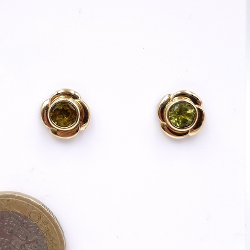 7 - A pair of peridot stud earrings set in nine carat gold. Weight - 2.08 grams.