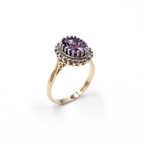 9 - Star lot : A lovely example of a nine carat gold amethyst gemstone ring set with diamond surround. S... 