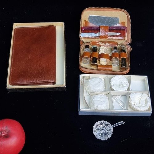 128 - Three vintage items including an Atlanta calf leather wallet, a travel vanity set and of glass salts... 