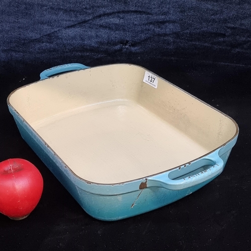 137 - A heavy cast iron double handled Le Creuset casserole dish, stamped to handles and base. (there is a... 