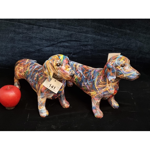 141 - A pair of vibrant and painterly figures in the forms of Dachshunds. Brand new from a top UK interior... 