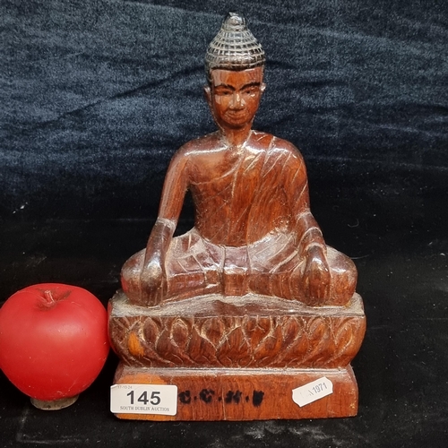 145 - A vintage hand carved wooden sculpture of a seated Buddha indistinct initials to base. Nice weight t... 