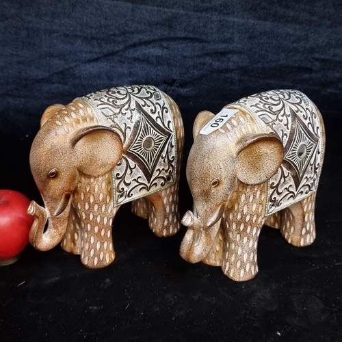 160 - A pair of decorative elephant figures. Measurements approx. 20cm length x 18cm height.