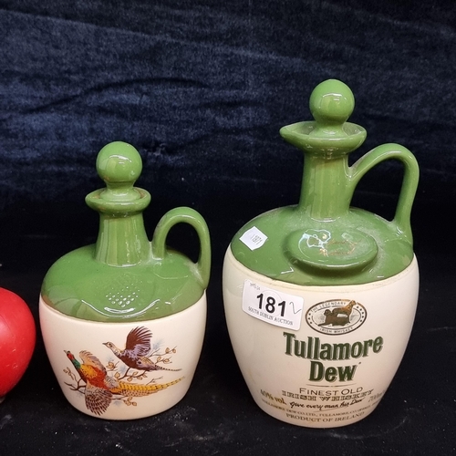 181 - Two empty whiskey flagons including a Tullamore Dew example both with original cork stoppers.