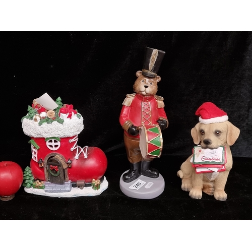 240 - Three charming Christmas decorations including a cute puppy figure and an elf's house in the form of... 