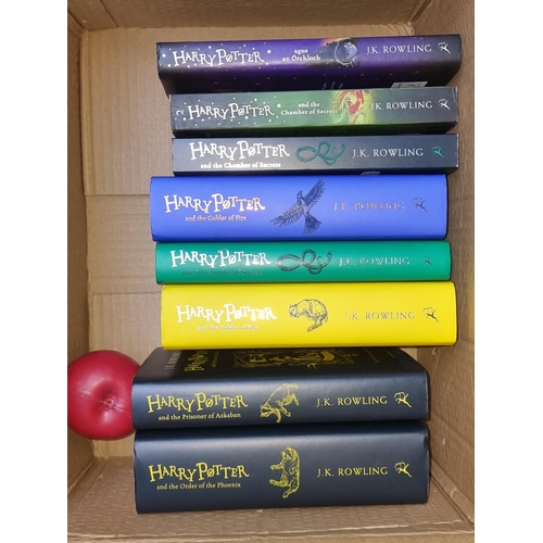 319 - A collection of eight Harry Potter books including five House Editions, two Chamber of Secrets and o... 