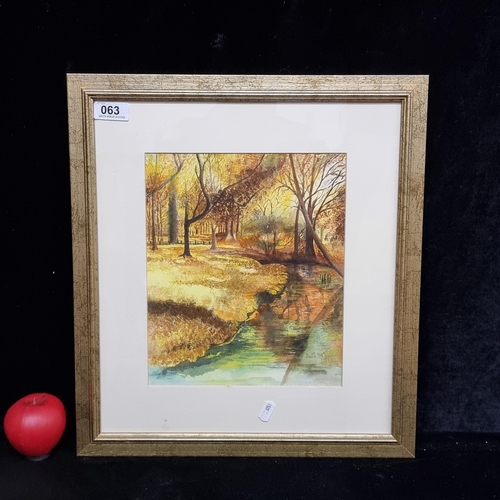 63 - A lively original watercolour on paper painting. Features an autumnal river landscape. Rendered in a... 