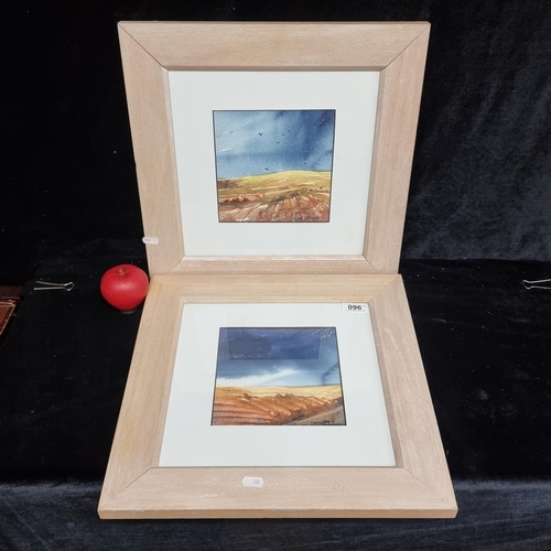 96 - A pair of striking watercolour on paper paintings featuring dark skied landscapes and ploughed field... 