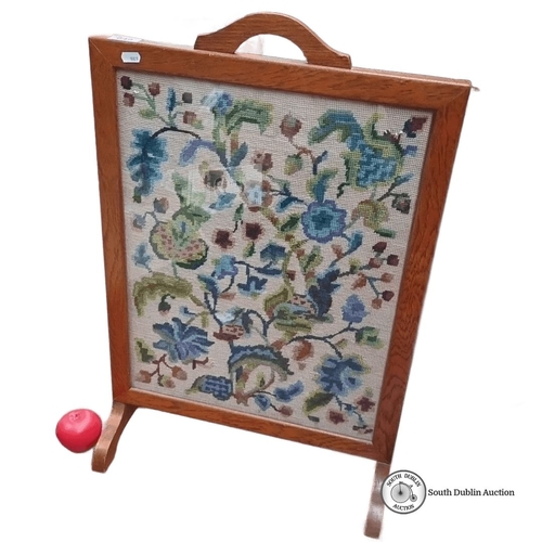 649 - Antique oak firescreen with floral needlepoint, approximately 60cm x 80cm. Front features vibrant ta... 