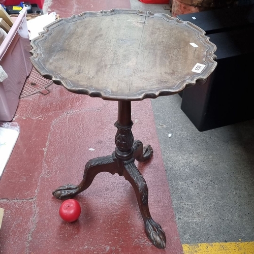 650 - Antique mahogany pie crust  wine table by Pim Bros. Ltd, Dublin, features a finely carved tripod bas... 