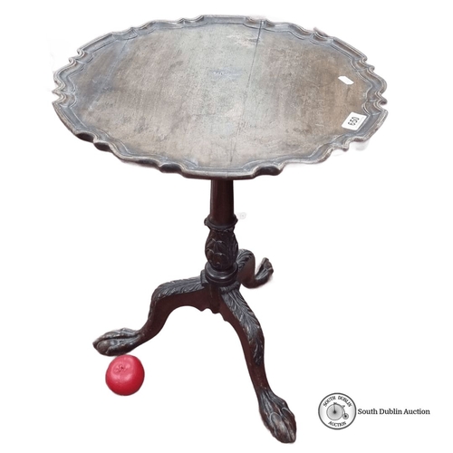 650 - Antique mahogany pie crust  wine table by Pim Bros. Ltd, Dublin, features a finely carved tripod bas... 