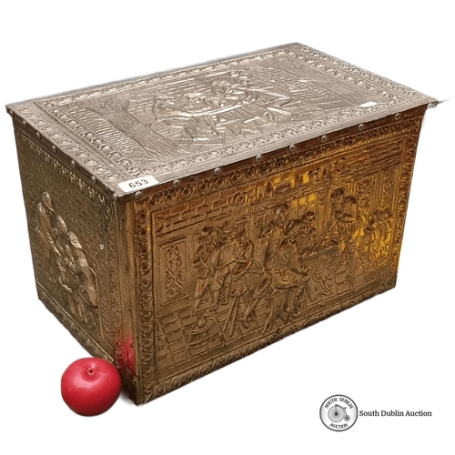 653 - Brass embossed storage chest with intricate figurative scenes and a hinged lid. Approximately 24