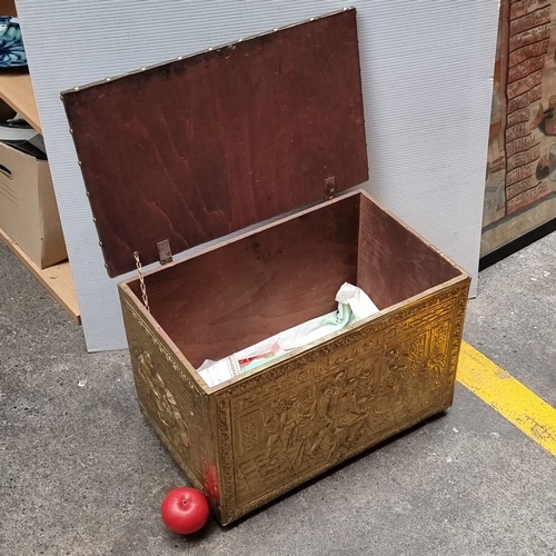 653 - Brass embossed storage chest with intricate figurative scenes and a hinged lid. Approximately 24