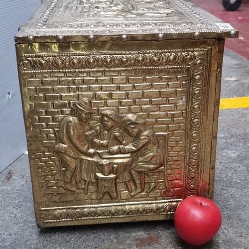 653 - Brass embossed storage chest with intricate figurative scenes and a hinged lid. Approximately 24