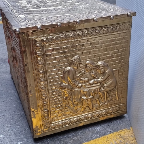 653 - Brass embossed storage chest with intricate figurative scenes and a hinged lid. Approximately 24