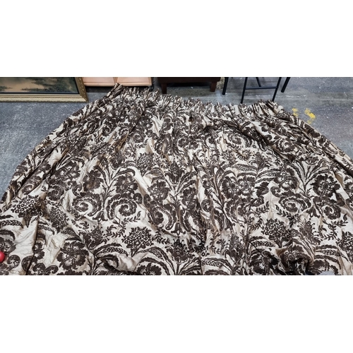 654 - Pair of heavy brocade lined curtains in rich brown floral pattern, lined. Approximately 110 inches w... 