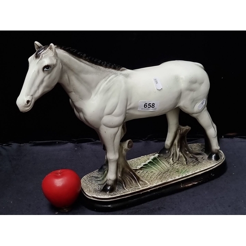 658 - A large Porcelain horse figurine on an oval base, featuring a detailed and lifelike design. Approxim... 